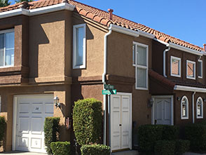 Residential end unit featuring a one-bedroom situated above garages